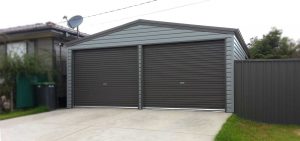 Double steel garage in horizontal M cladding with roller doors by Judds Garages