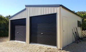 Double monopitch garages in vertical K panel cladding near Belmont
