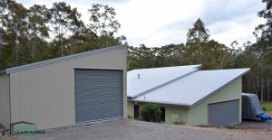 Single monopitch garage with non-standard roof pitch to match existing house, in vertical K panel cladding